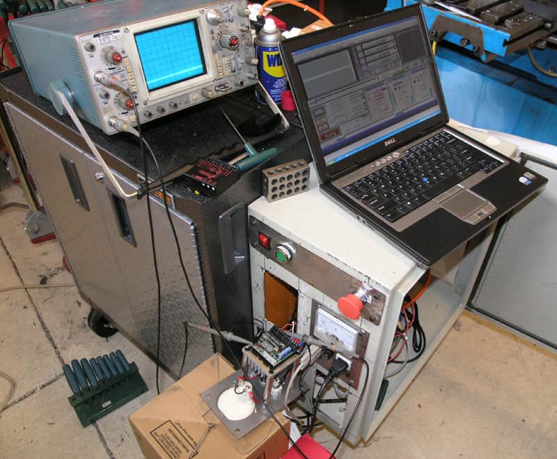 Cluttered workshop floor with tools and equipment for machining and metal fabrication projects.
