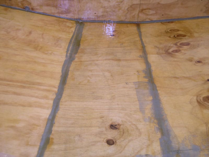 Plywood with visible light-colored wood grain.