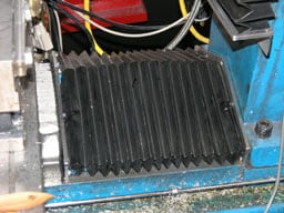 Close-up photo of blue metal object with black rubber cover.