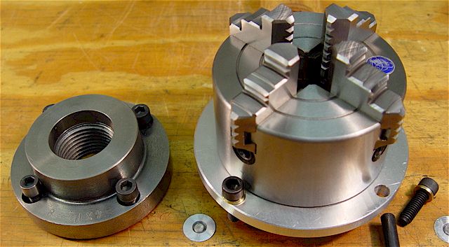 Metal parts featuring 4-jaw chuck and adapter plate.