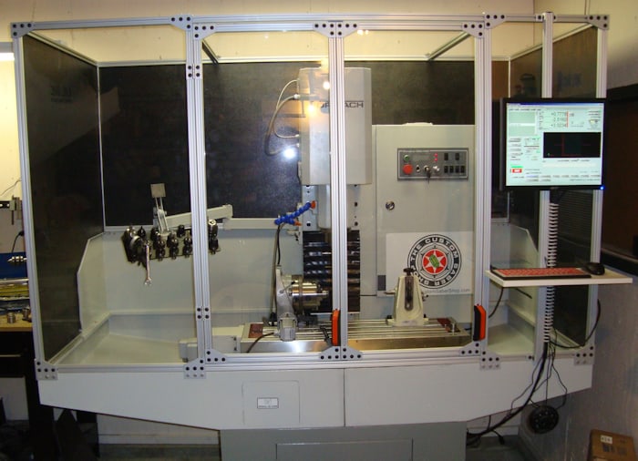 Large metalworking machine with control panel in foreground.