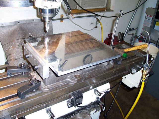 A CNC machine is being used to make a piece of metal.