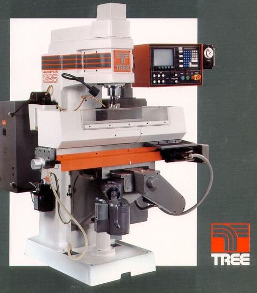 A tree brand CNC milling machine with a digital display and orange trim, presented against a gray background.