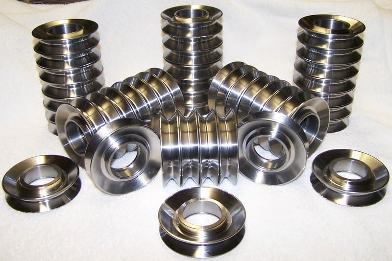 A group of stainless steel parts on a white surface, featured in the CNC Blog Archive from 2008.