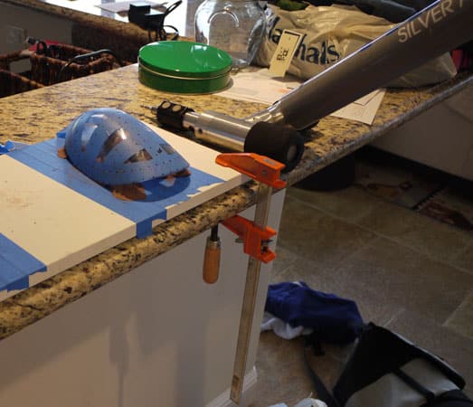 A granite countertop with a Faro arm on top, surrounded by tools and materials.
