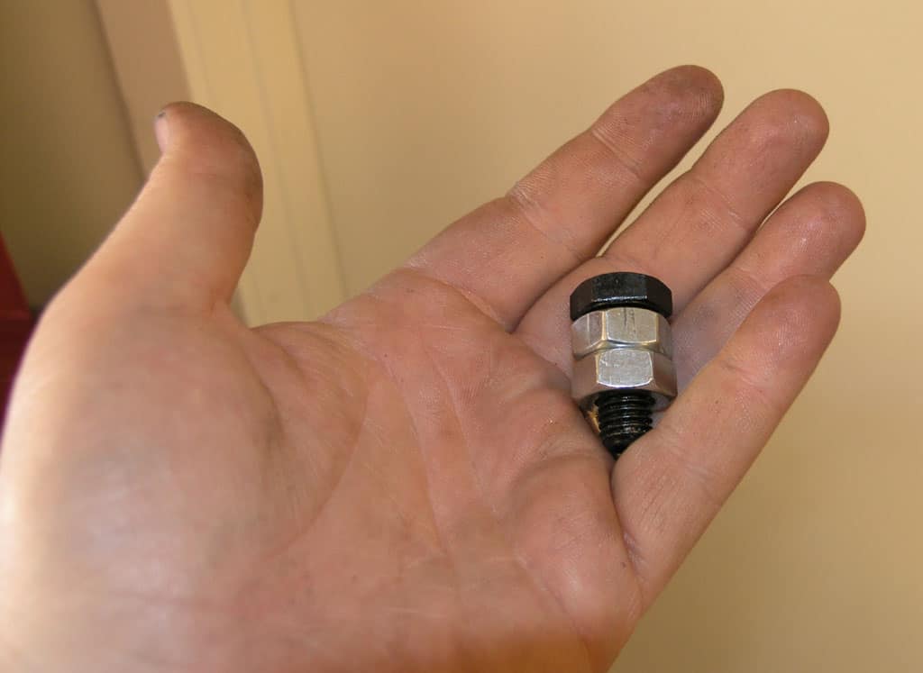 A hand holding a hex-key wrench.