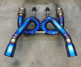 Blue metal exhaust system component with curved pipes and metallic finish.