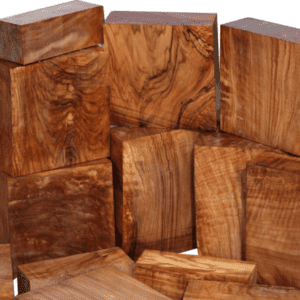 Dark brown wooden blocks with visible grain patterns stacked haphazardly against a white background.