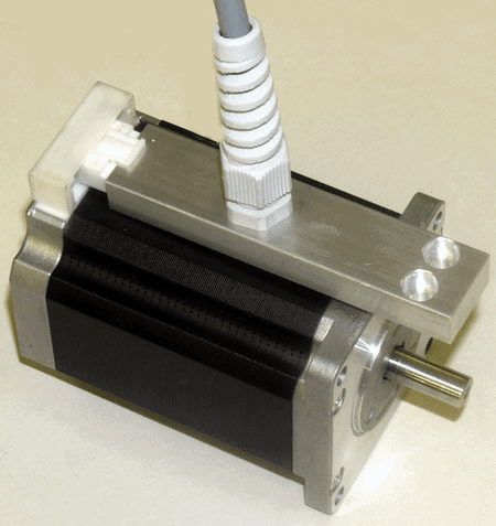 Small metallic device with cylindrical shape, flat top, and longitudinal grooves.