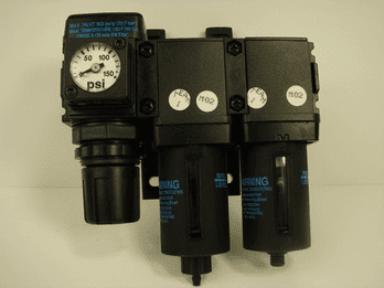 Black air filter regulator with psi dial and warning label on a beige background.