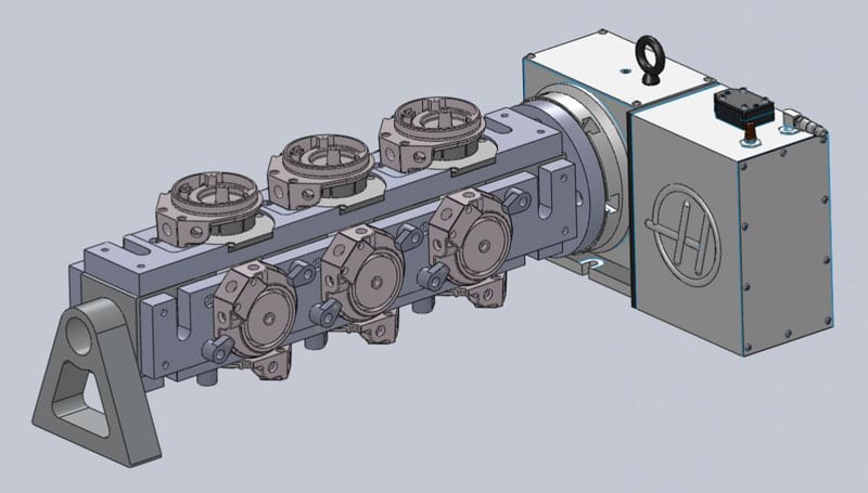 Metal tombstone for VMC machining with four linearly arranged holes of varying diameters and three circular components.