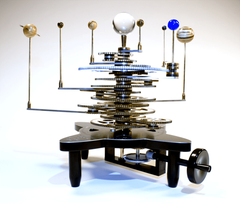 Gears and spheres in an ornate mechanical device.