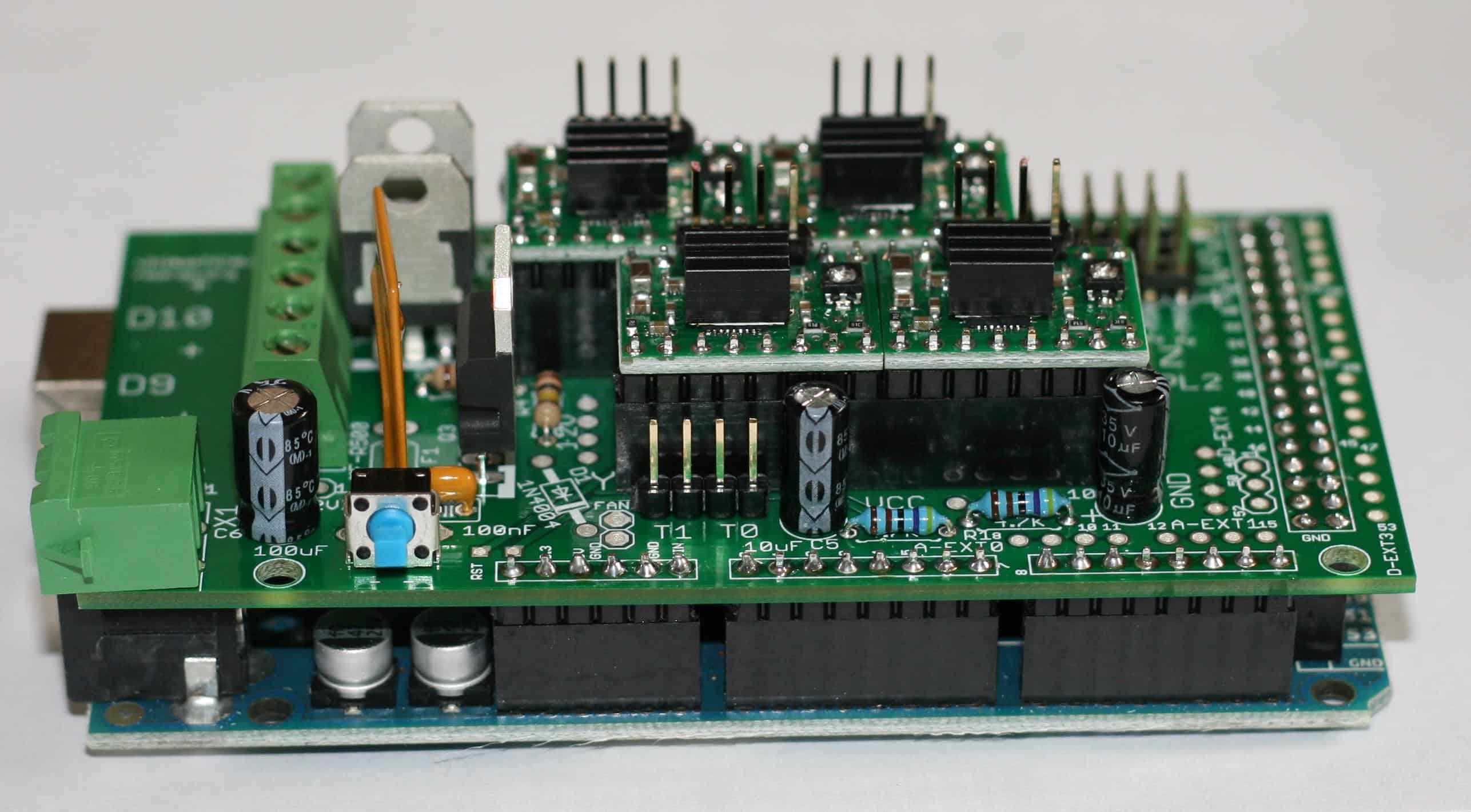 Green circuit board with various components and connectors used in machining and metal fabrication contexts.