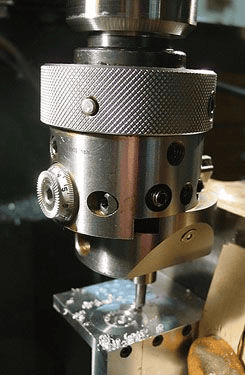 Metal component with threaded holes and knurled surface.