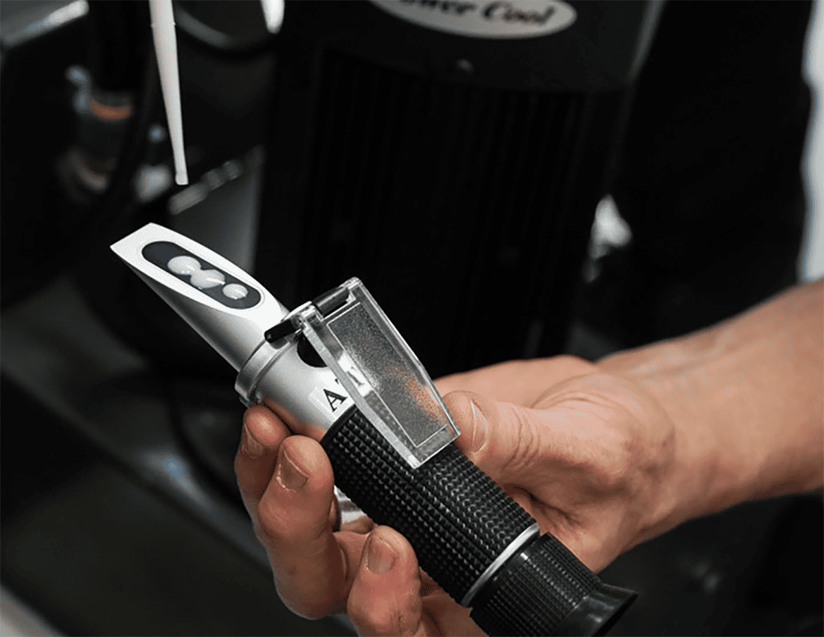 Measuring coolant concentration with a refractometer.